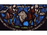 Two weary spies straining beneath a huge bunch of grapes - a stained glass window from Canterbury Cathedral, England